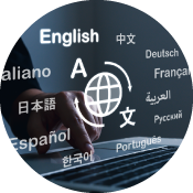 Hand on laptop with words for multiple languages floating around a globe icon.