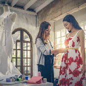 Woman measuring the waist of another woman for a bridal dress alteration